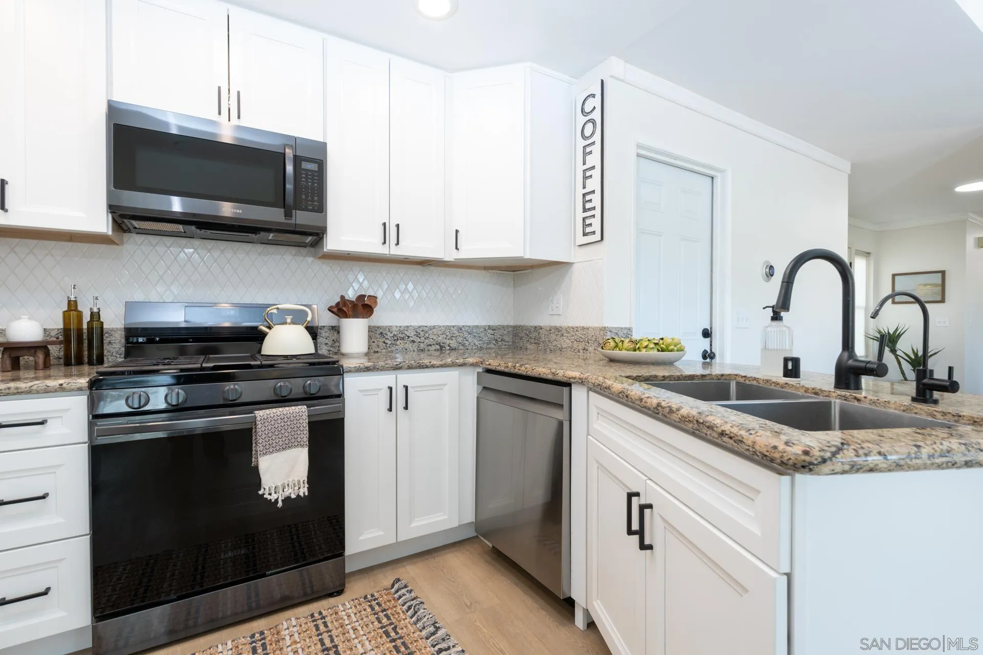 10354 Settle Road Santee, CA 92071 - Photo 9 of 56 a kitchen with stainless steel appliances granite countertop a stove a sink and a microwave