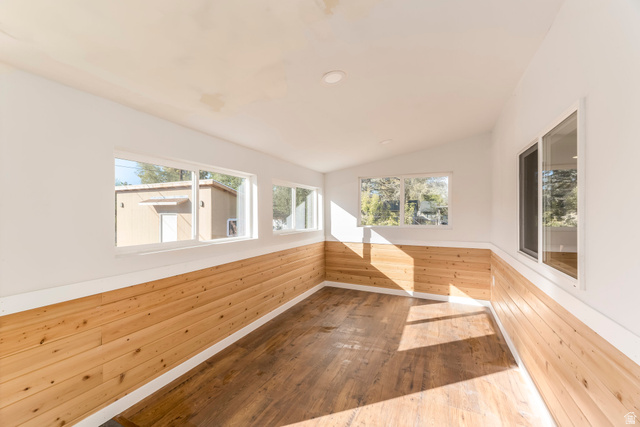 4658 Box Elder Street Salt Lake City, UT 84107 - Photo 13 of 17 Bright room featuring wood-finish flooring, white walls, and natural wood paneling