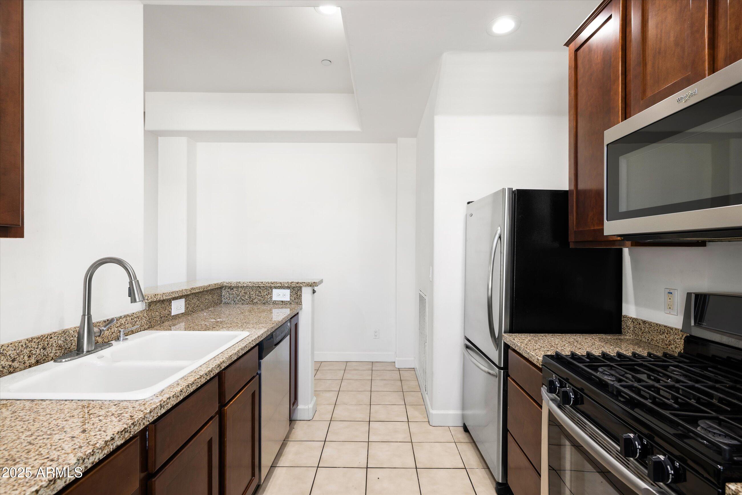 505 West 6th Street Tempe, AZ 85281 - Photo 15 of 32 a kitchen with stainless steel appliances granite countertop a sink stove and refrigerator