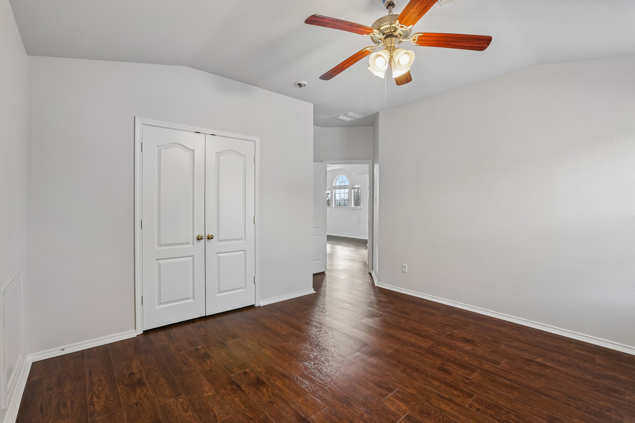 1721 Long Rifle Drive Austin, TX 78754 - Photo 29 of 38 Rich hardwood-style flooring extends through this airy room, highlighted by the classic ceiling fan.
