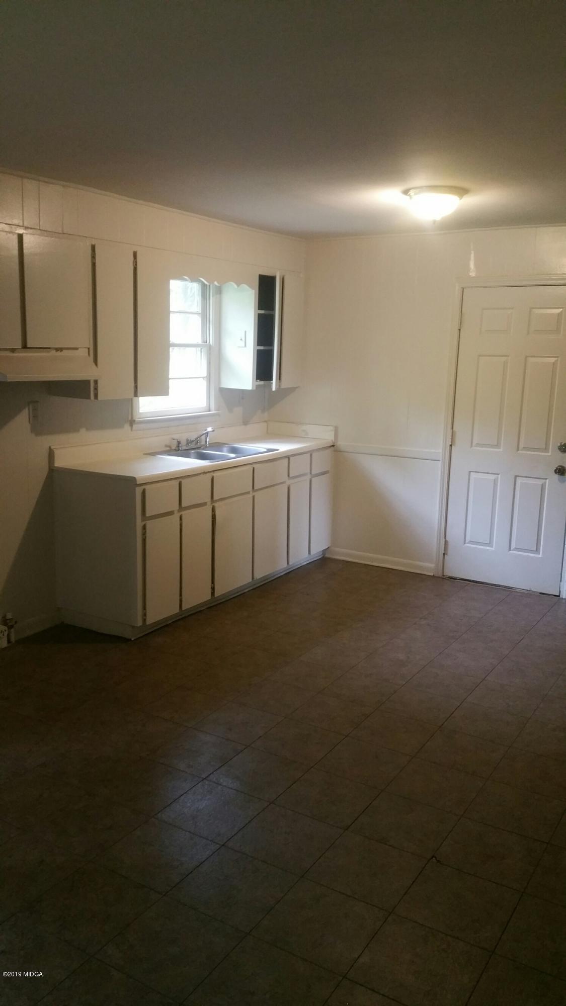 4843 Brookhaven Road Macon, GA 31206 - Photo 3 of 7 a room with a window and cabinet