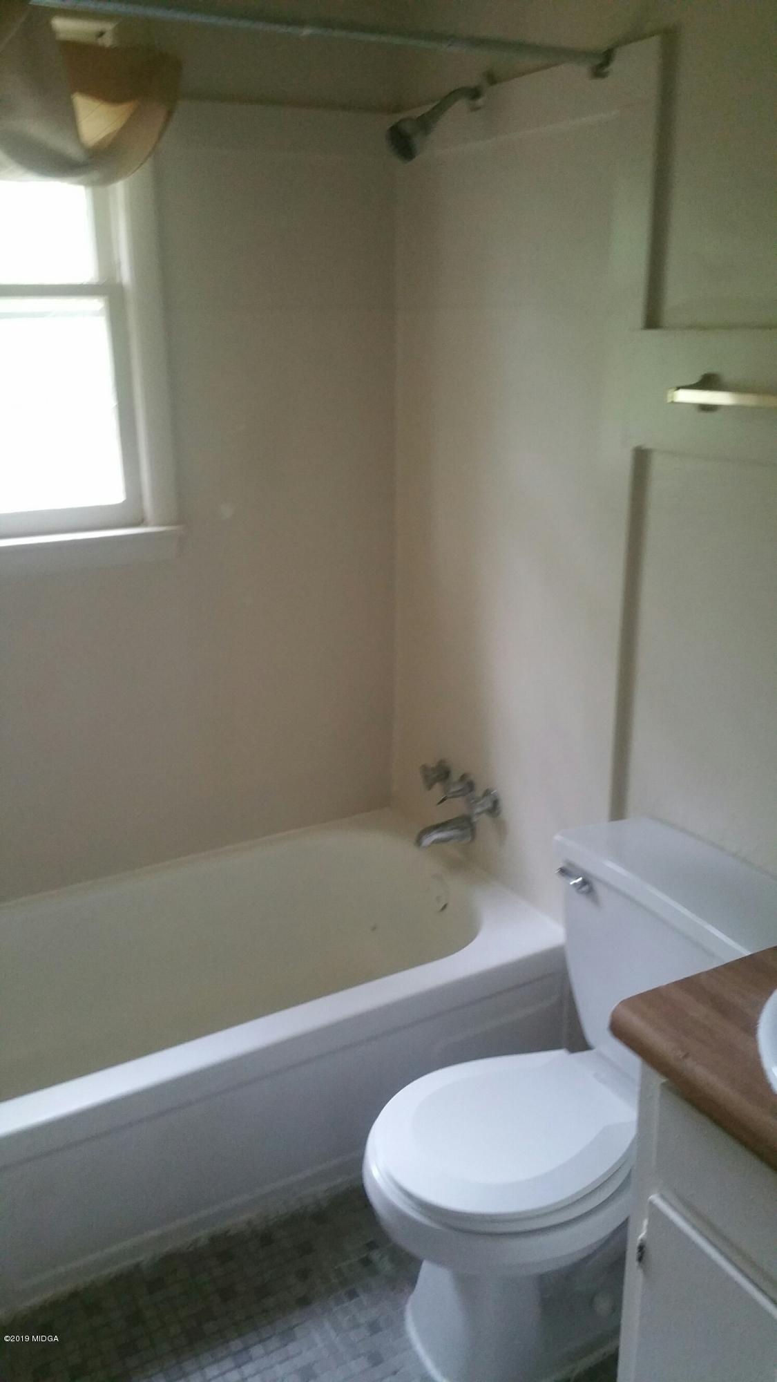 4843 Brookhaven Road Macon, GA 31206 - Photo 5 of 7 a white toilet sitting next to a bath tub