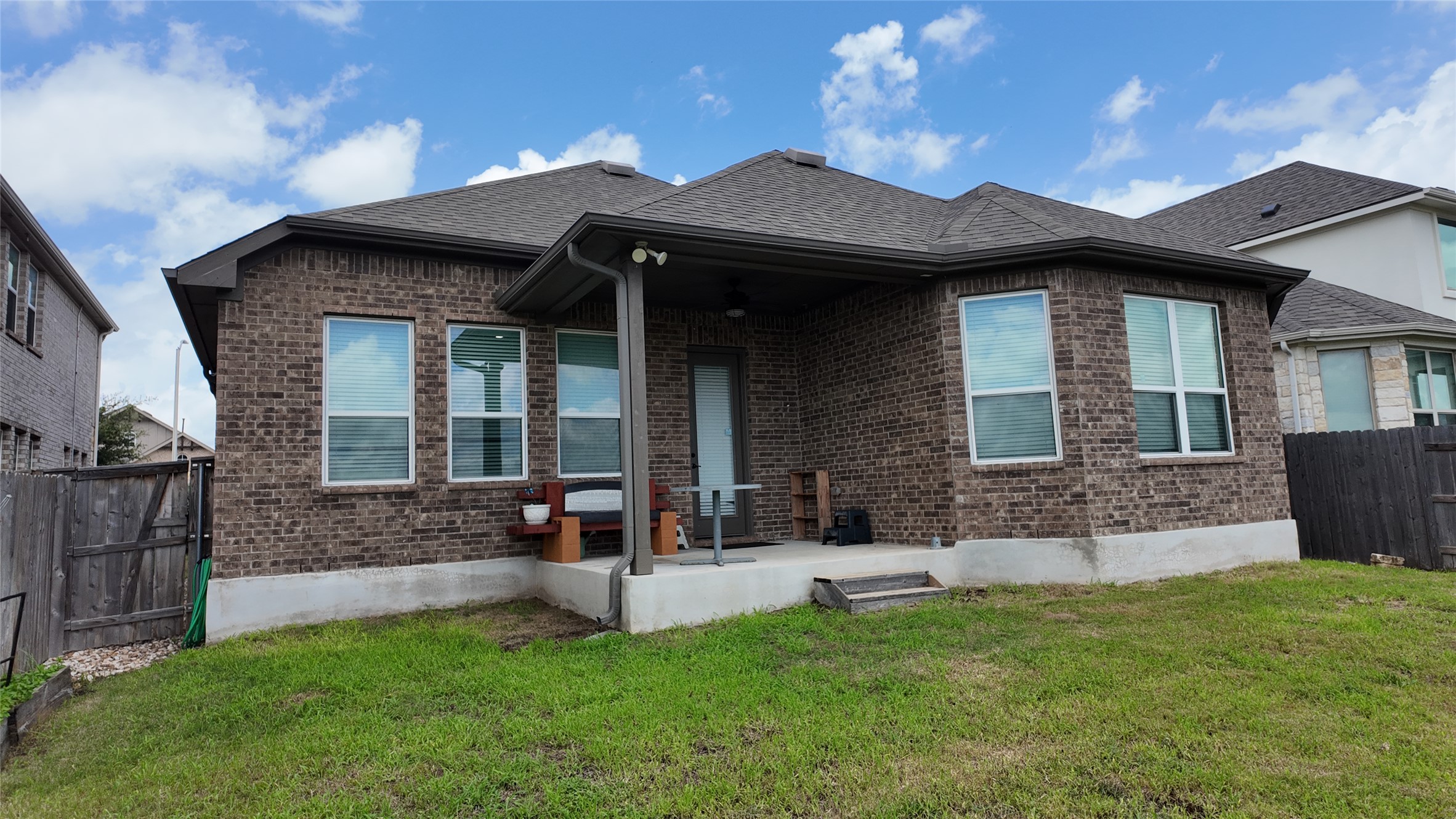 2320 Base Burner Path Leander, TX 78641 - Photo 24 of 24 A well-maintained brick exterior with a welcoming covered patio overlooks a lush, private yard.