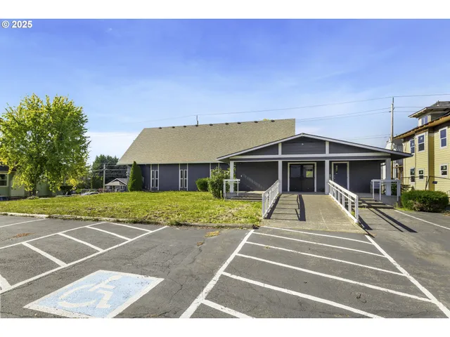 a view of a big building with yard and entertaining space