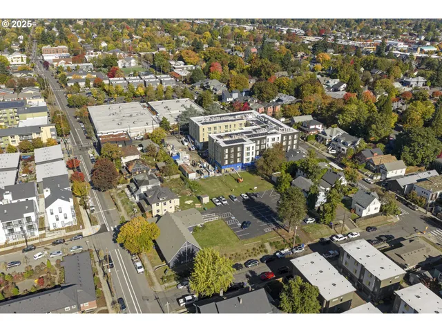 an aerial view of a residential building with parking