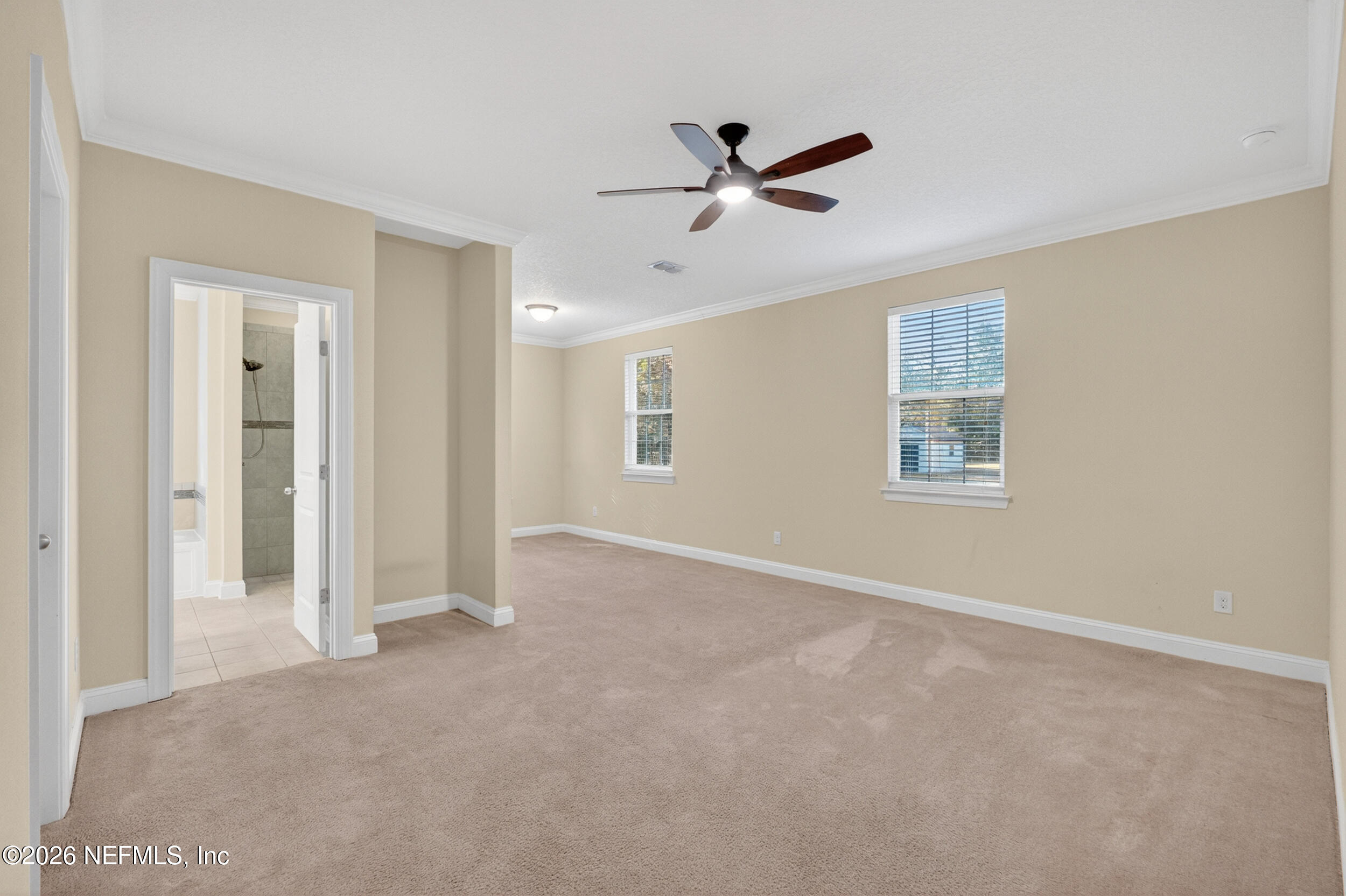 13576 Dunn Creek Road Jacksonville, FL 32218 - Photo 12 of 54 a view of a livingroom with a ceiling fan & windows