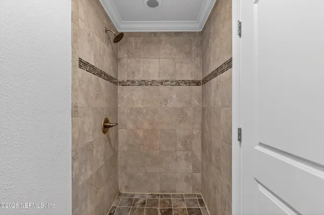 a bathroom with a glass door shower