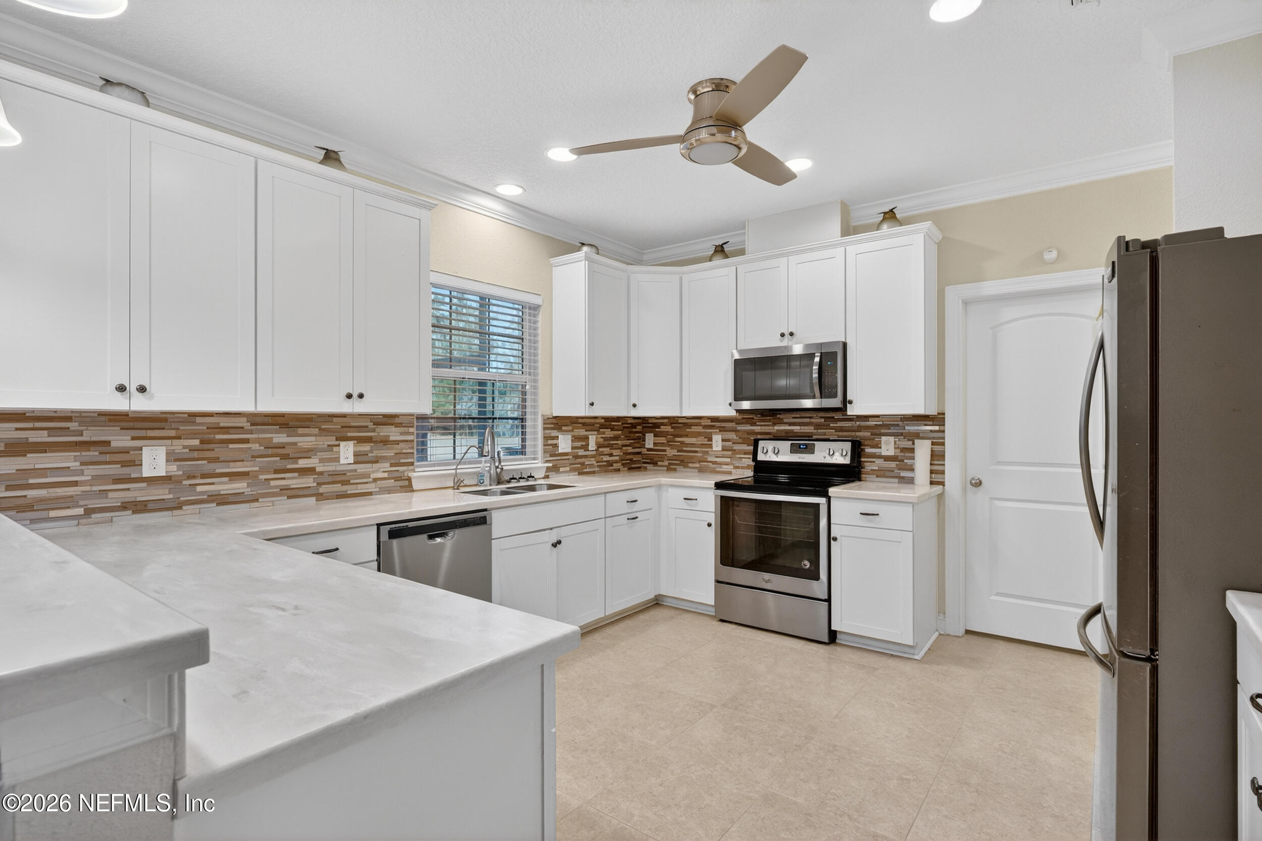 13576 Dunn Creek Road Jacksonville, FL 32218 - Photo 22 of 54 a kitchen with granite countertop a refrigerator stove top oven and sink
