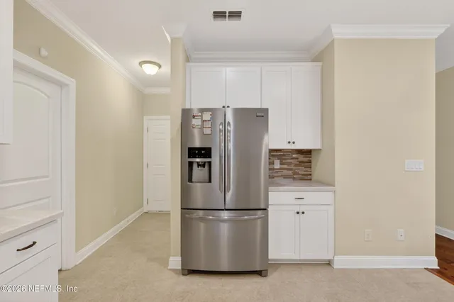 a refrigerator freezer sitting in a kitchen