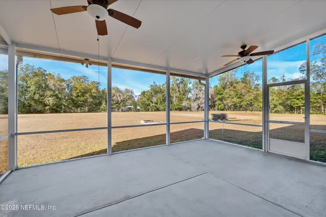 a view of an empty room with sliding glass door