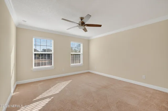 a view of a livingroom with a ceiling fan and window