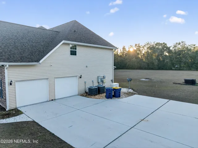 a view of a house with patio and yard