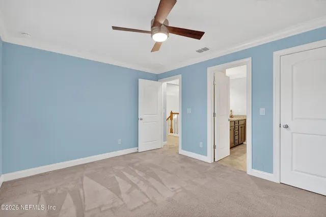a view of empty room with a ceiling fan