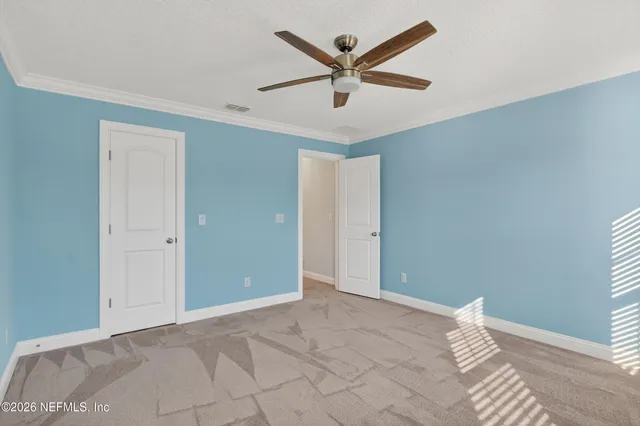 a view of a livingroom with a ceiling fan and wooden floor