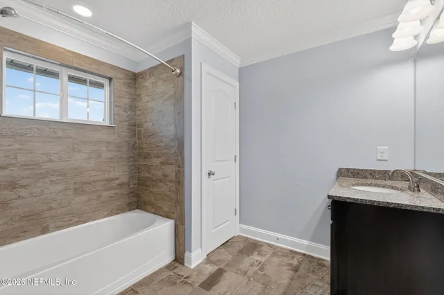 a bathroom with a tub sink and a toilet