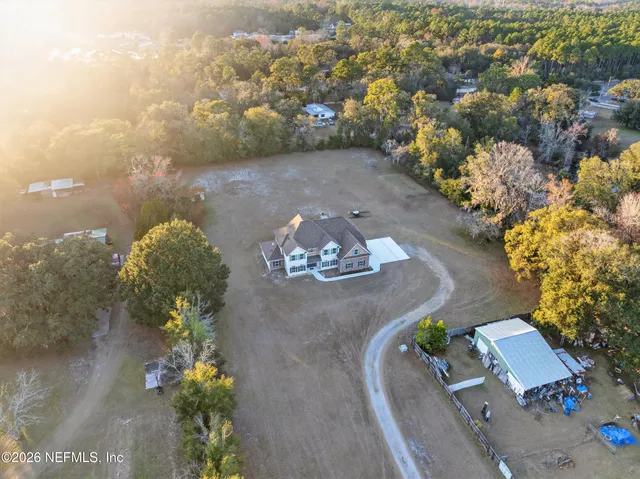 an aerial view of a house with a yard and a garden