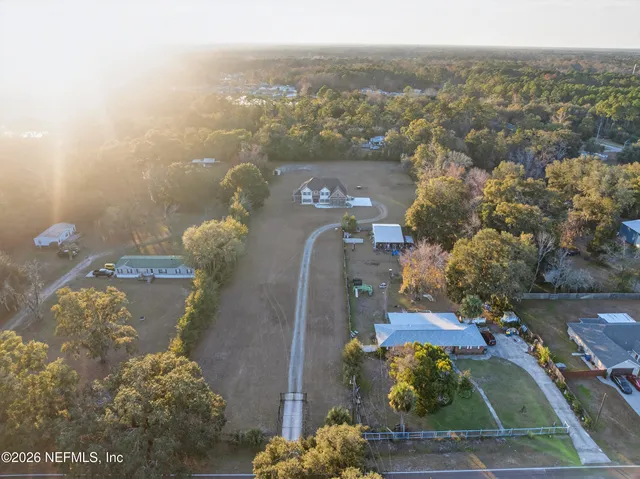 an aerial view of a house with a yard