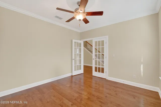 wooden floor in an empty room with a window
