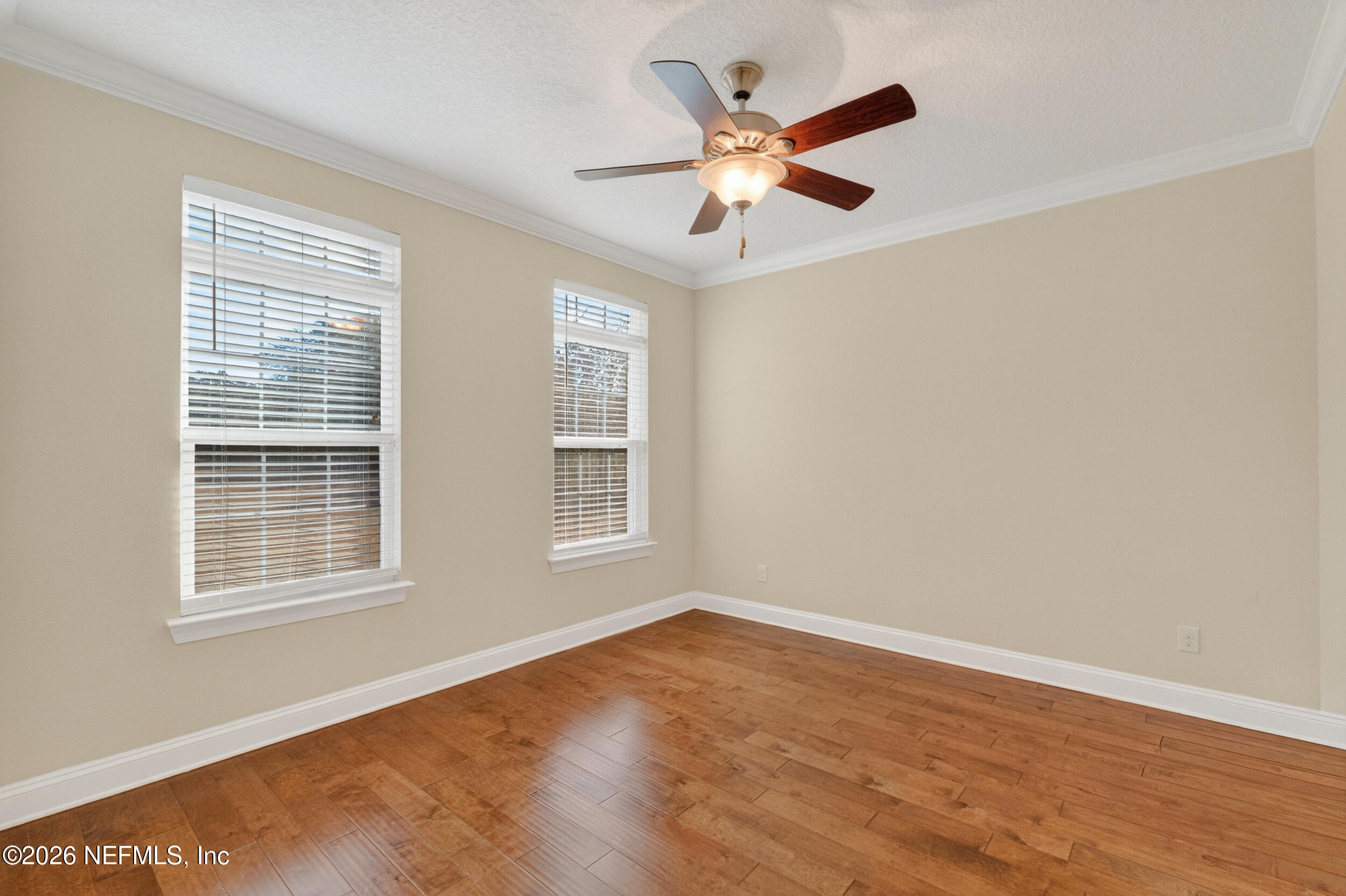 13576 Dunn Creek Road Jacksonville, FL 32218 - Photo 9 of 54 a view of an empty room with wooden floor and a window