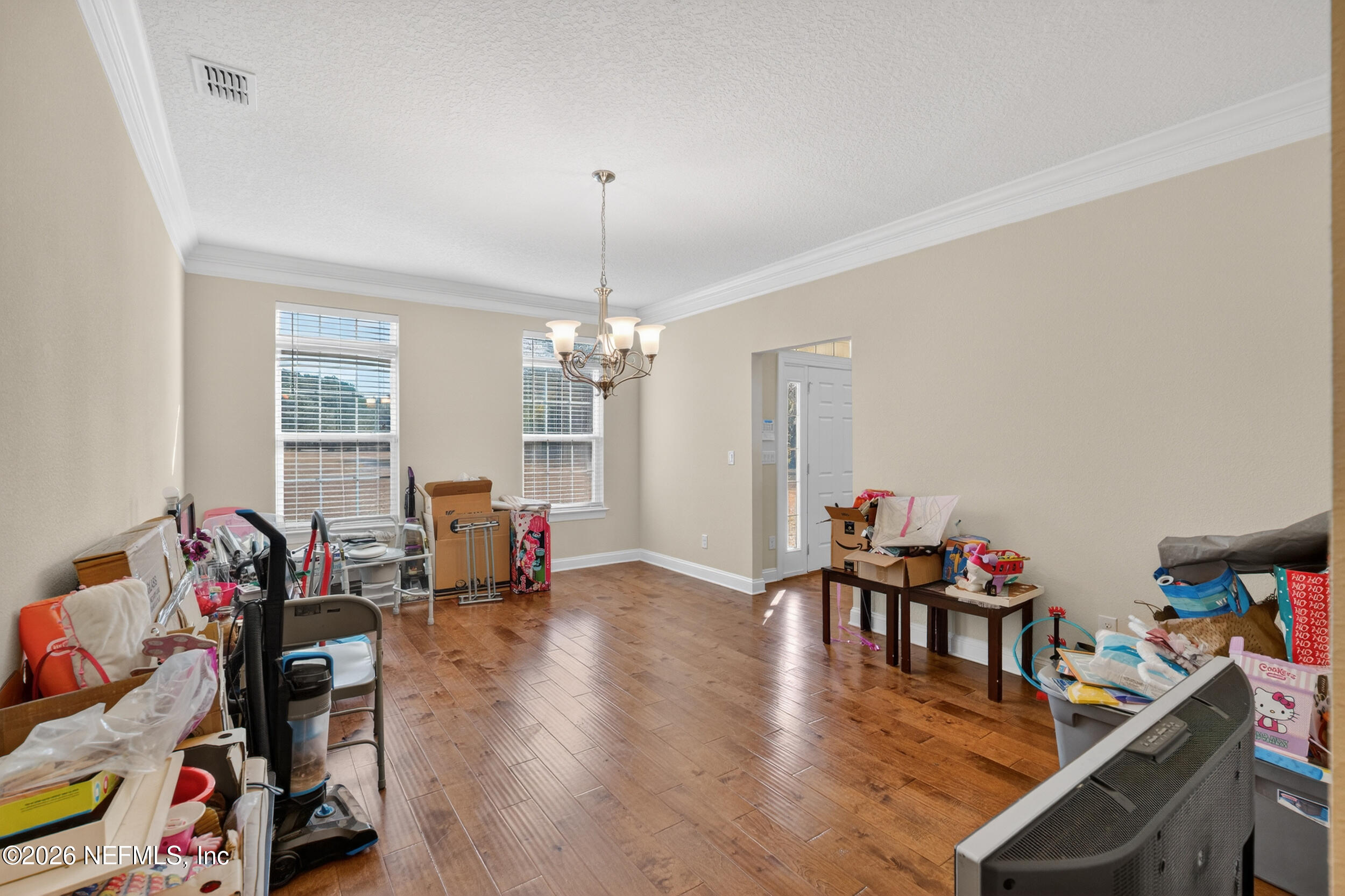 13576 Dunn Creek Road Jacksonville, FL 32218 - Photo 10 of 54 a living room with furniture and a chandelier