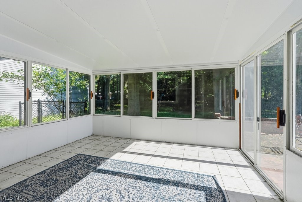 136 Pinehurst Road Munroe Falls, OH 44262 - Photo 31 of 48 Bright sunroom featuring white paneled walls and ceiling, extensive window coverage, and tile flooring