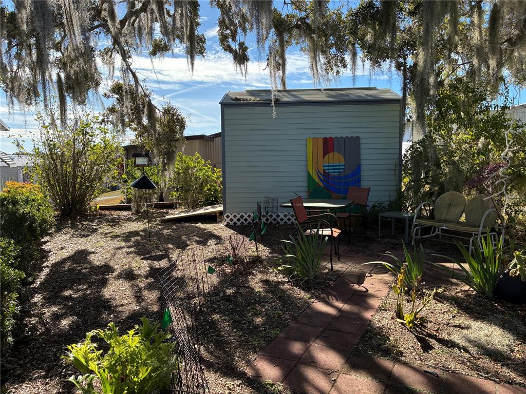 3896 Picciola Road, Unit 213 Fruitland Park, FL 34731 - Photo 2 of 12 a backyard of a house with lots of green space