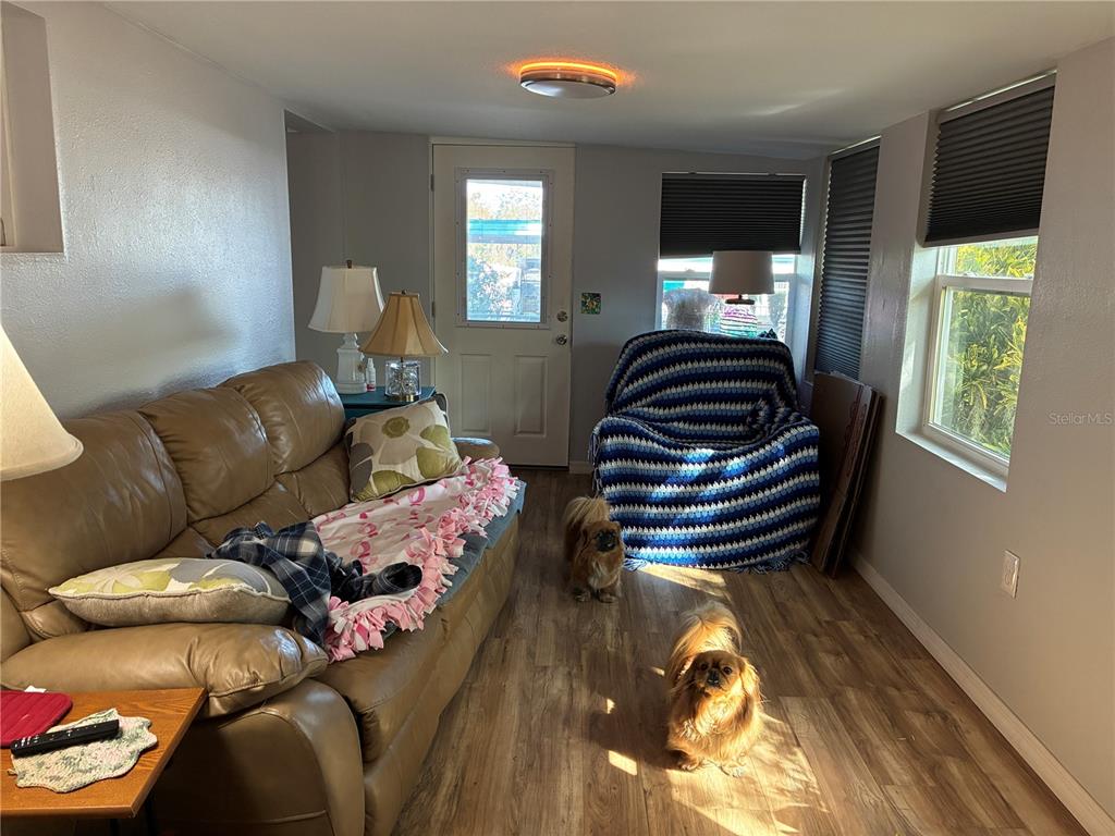 3896 Picciola Road, Unit 213 Fruitland Park, FL 34731 - Photo 10 of 12 a living room with furniture and a large window
