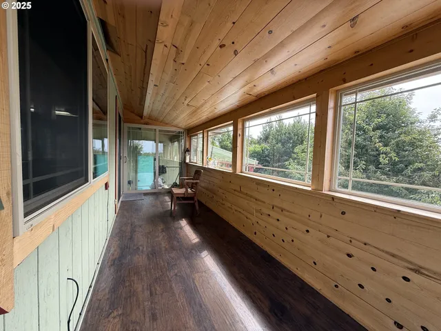 a view of a room with wooden floor and furniture