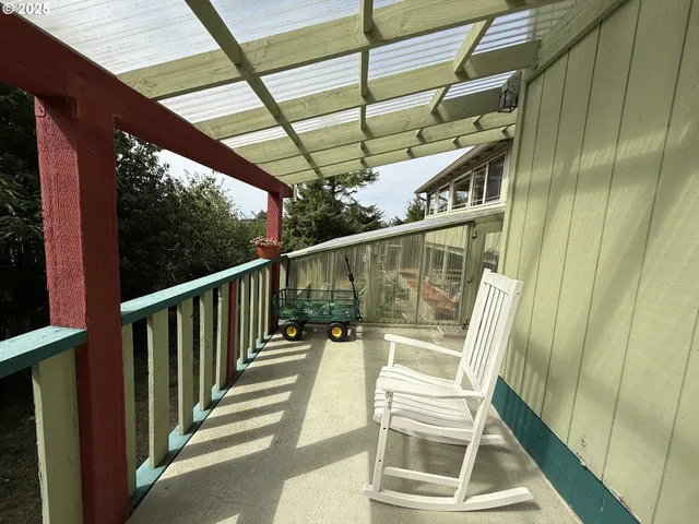a view of balcony with wooden floor and door