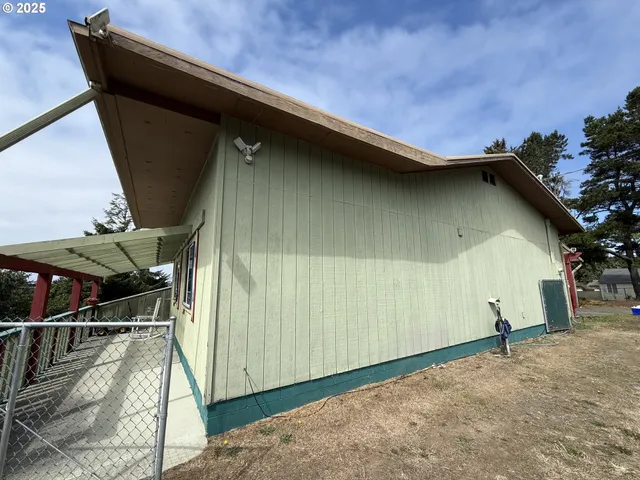 a backyard of a house with table and chairs