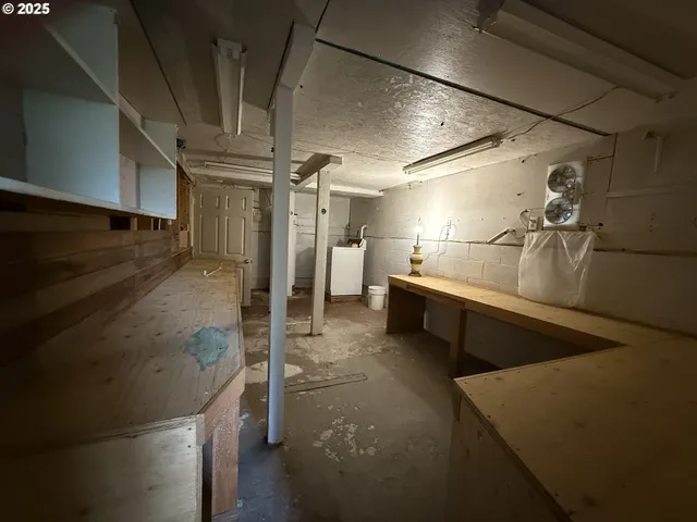 a bathroom with a glass door shower a sink and a stove