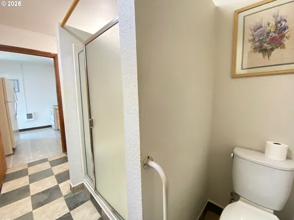 a white toilet sitting next to a small bathroom