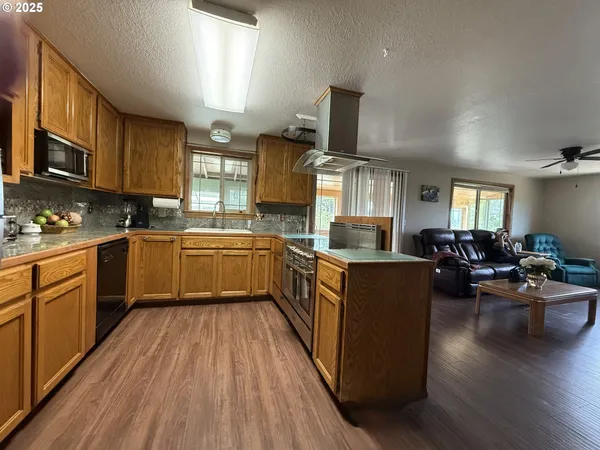 a kitchen with wooden floors and wooden cabinets