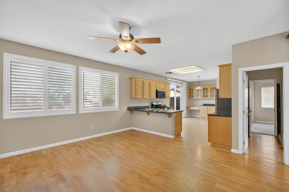 5817 Spring Flower Drive Elk Grove, CA 95757 - Photo 16 of 62 a view of a living room and kitchen with a large window