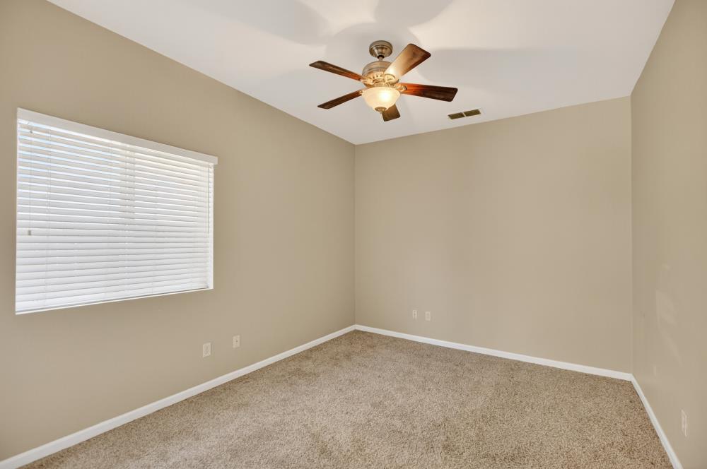 5817 Spring Flower Drive Elk Grove, CA 95757 - Photo 23 of 62 an empty room with a window and a ceiling fan