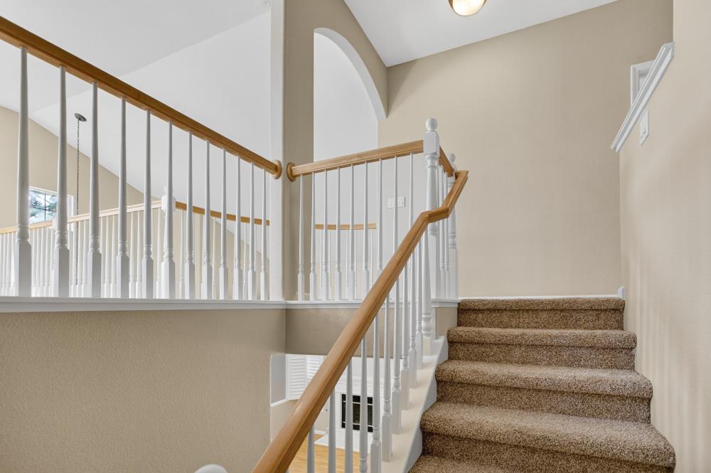 5817 Spring Flower Drive Elk Grove, CA 95757 - Photo 27 of 62 a view of staircase with wooden floor and white walls