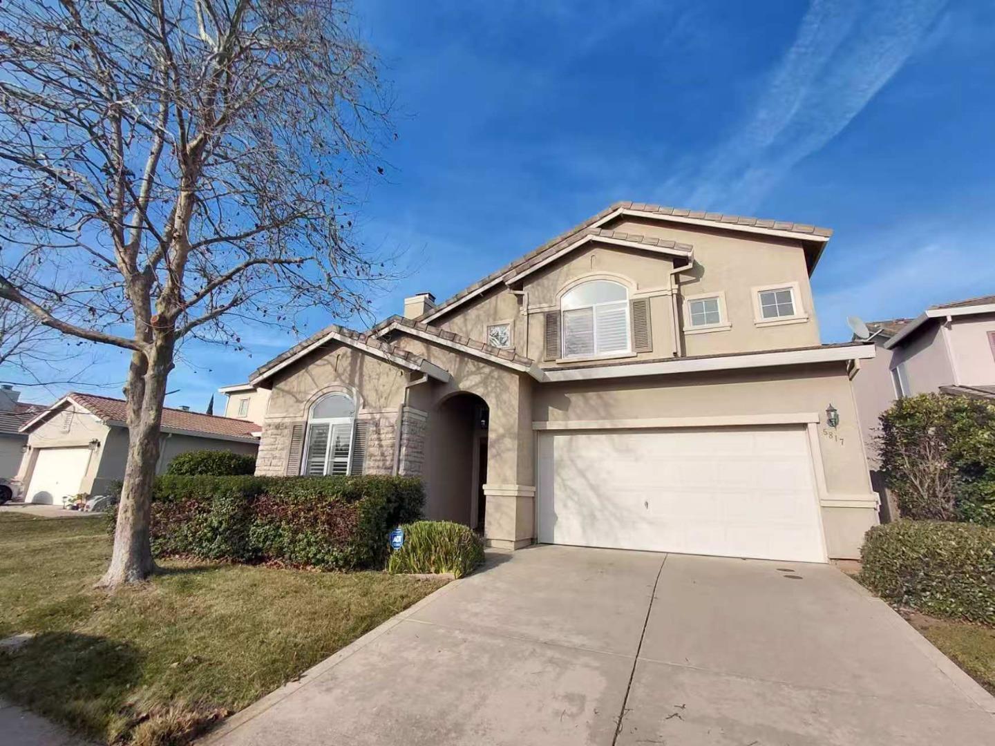 5817 Spring Flower Drive Elk Grove, CA 95757 - Photo 3 of 62 a front view of a house with a yard and garage