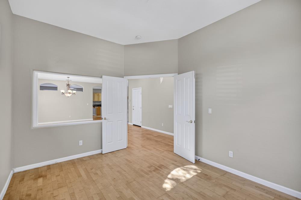 5817 Spring Flower Drive Elk Grove, CA 95757 - Photo 9 of 62 an empty room with windows and entrance to other room