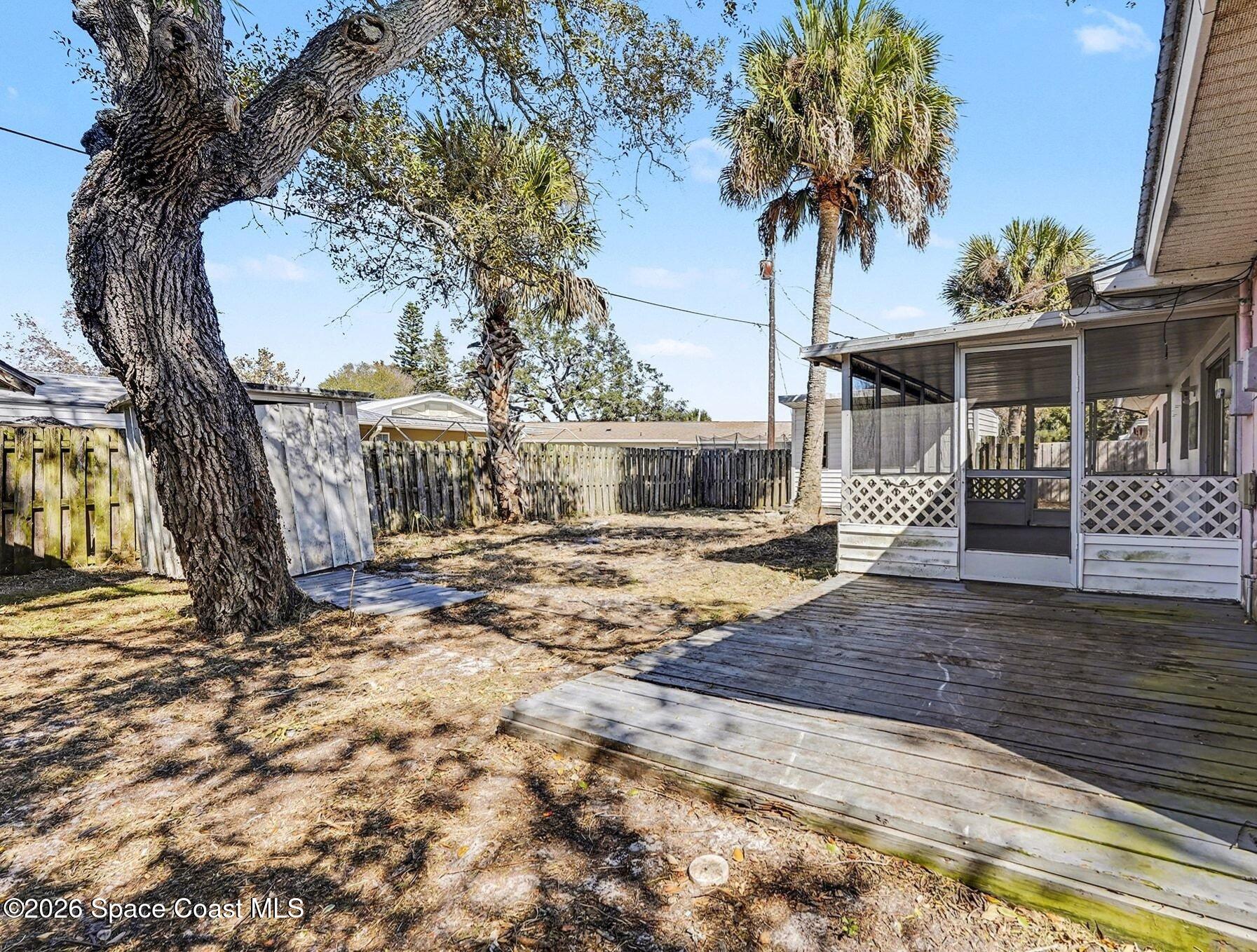 3205 Dade Circle Northeast Palm Bay, FL 32905 - Photo 24 of 35 a view of a house with a tree in the yard