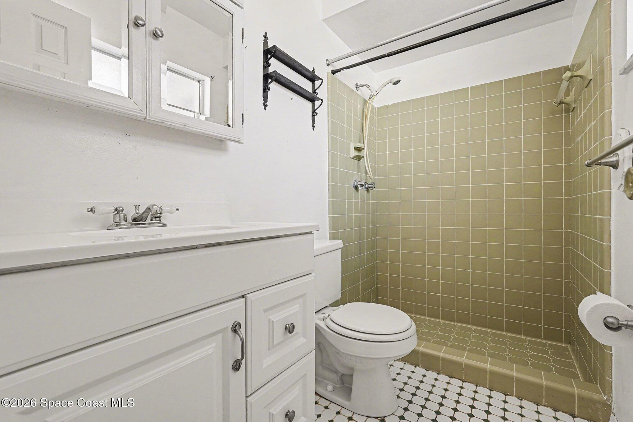 3205 Dade Circle Northeast Palm Bay, FL 32905 - Photo 4 of 35 a bathroom with a sink a toilet and shower