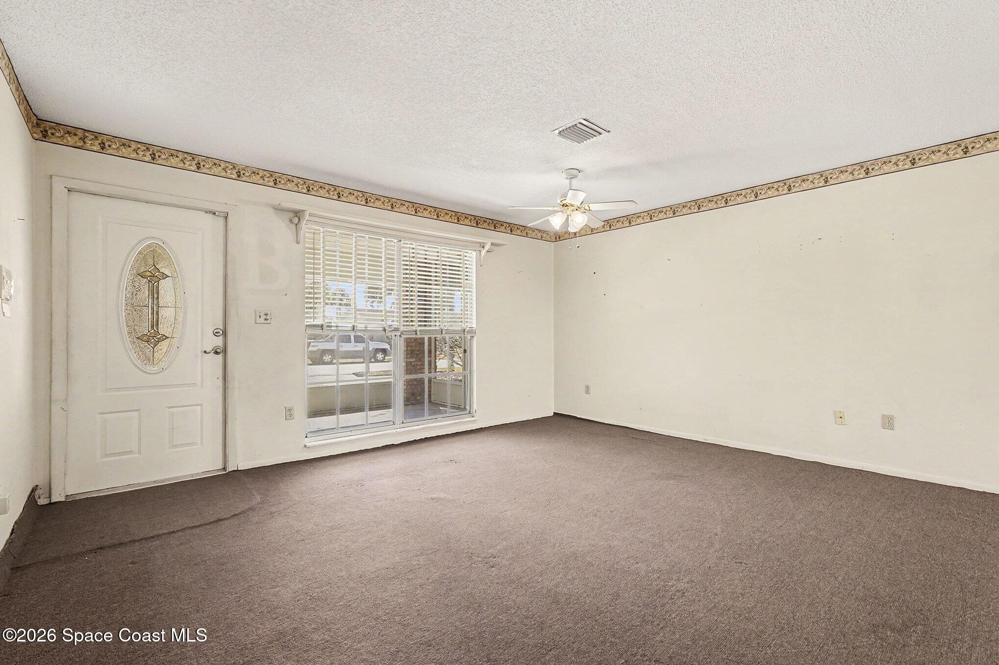 3205 Dade Circle Northeast Palm Bay, FL 32905 - Photo 8 of 35 a view of an empty room with a window