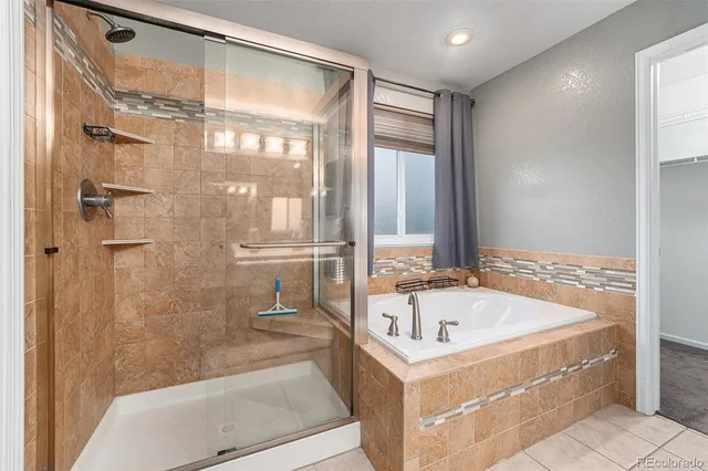 a white bath tub sitting next to a shower