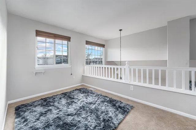 a view of wooden floor and a window in a room