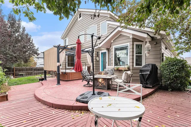 a view of a patio with table and chairs and wooden floor