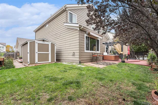 a backyard of a house with table and chairs
