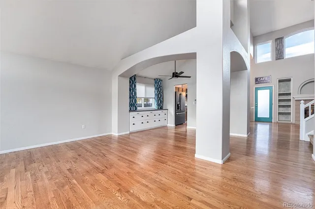a view of a hallway with wooden floor and furniture
