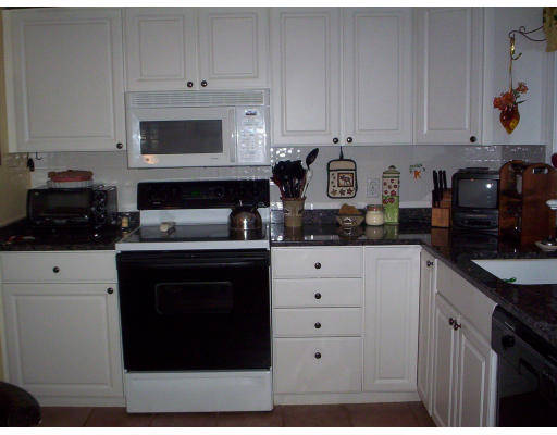 60 Dodge Road Sutton, MA 01590 - Photo 6 of 16 a kitchen with white cabinets and appliances