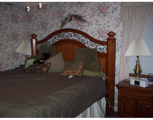60 Dodge Road Sutton, MA 01590 - Photo 10 of 16 a bed sitting in a bedroom next to a lamp