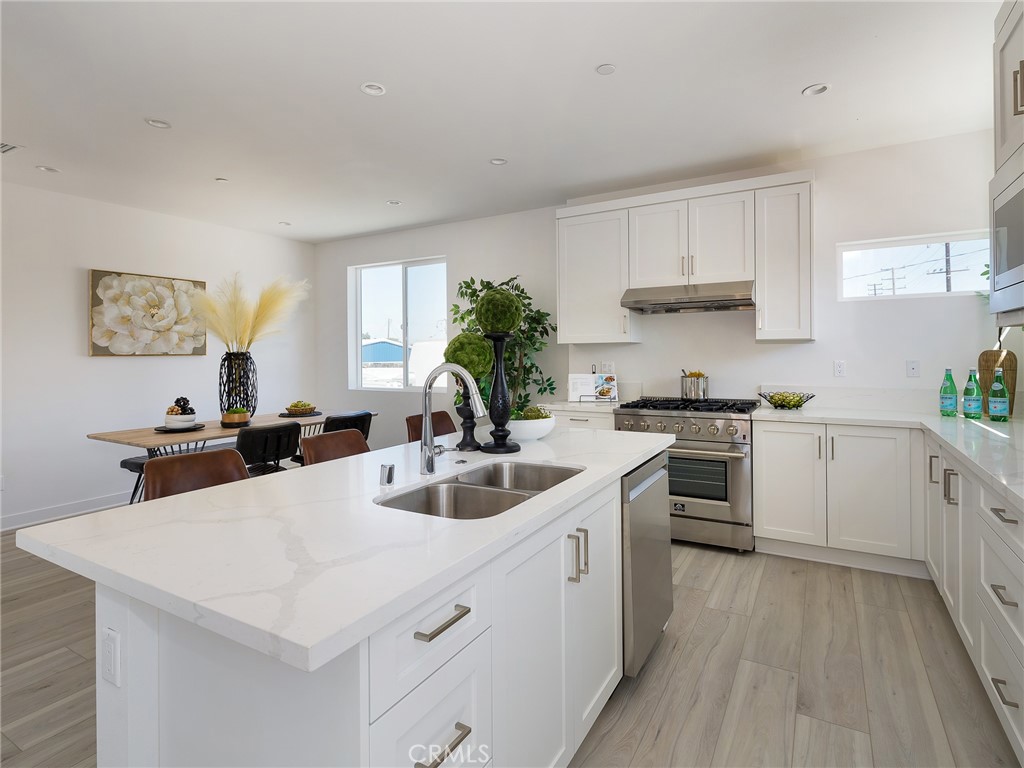 121 East 223rd Street, Unit 1 Carson, CA 90745 - Photo 11 of 35 a kitchen with a white cabinets and white appliances