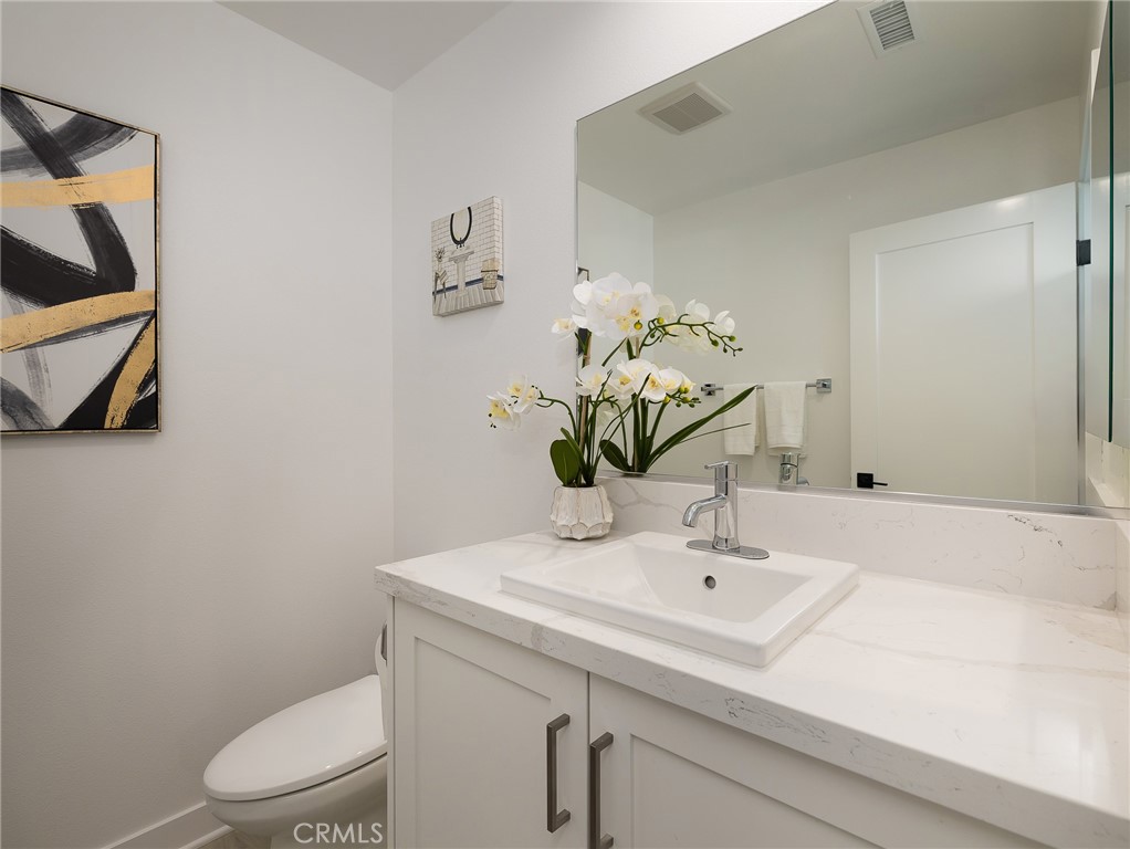 121 East 223rd Street, Unit 1 Carson, CA 90745 - Photo 13 of 35 a bathroom with a sink a toilet and mirror